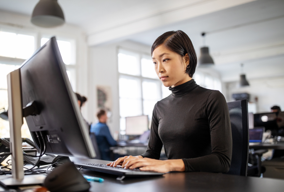 IITH employee focused on work at a computer in a modern office setting, supporting the company's aluminum industry projects